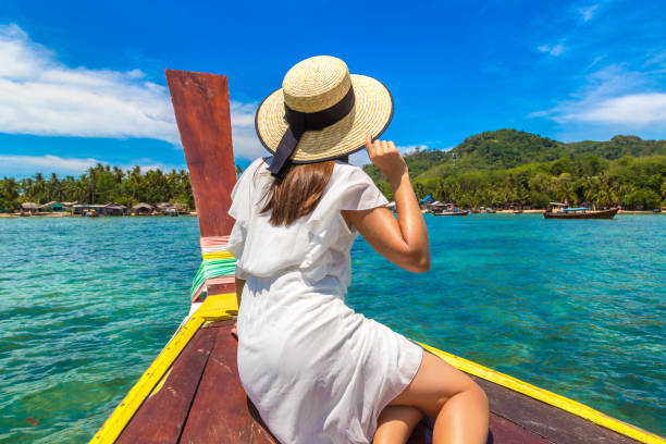 istock Woman on boat in Thailand 1345838427
