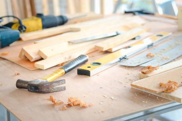 istock Carpenter working desk with different craft wood tools on wooden table, carpentry woodwork workshop for craftsman enjoys his DIY hobby. 1345838541
