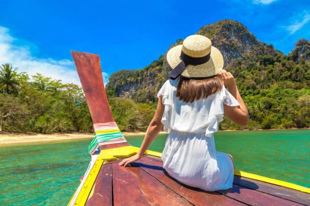 istock Woman on boat in Thailand 1345838554