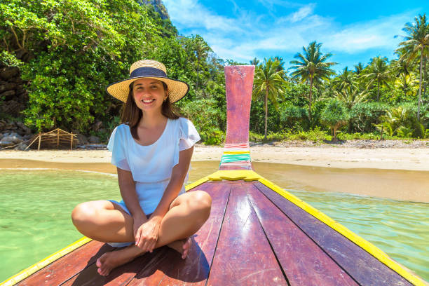 istock Woman on boat in Thailand 1345838610