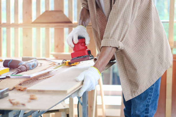istock Senior man carpenter working in carpentry woodwork workshop, old craftsman working with electric grinder on wood and enjoy his DIY hobby. 1345839775