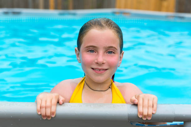istock Blond girl swimming in the pool with red cheeks 1345839928