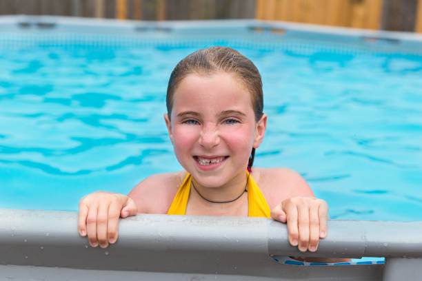 istock Blond girl swimming in the pool with red cheeks 1345839940
