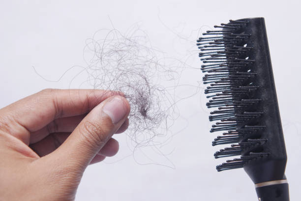 istock man hold his list hair close up 1345840012
