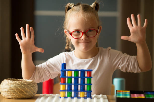 Girl with Down syndrome is preparing to go to first class Girl with Down syndrome is preparing to go to first class down syndrome stock pictures, royalty-free photos & images