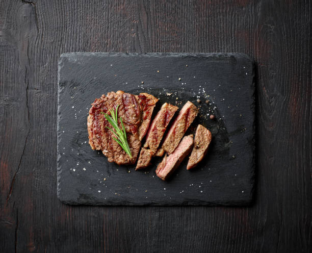 istock Grilled entrecote on stone board, from above 1345841059