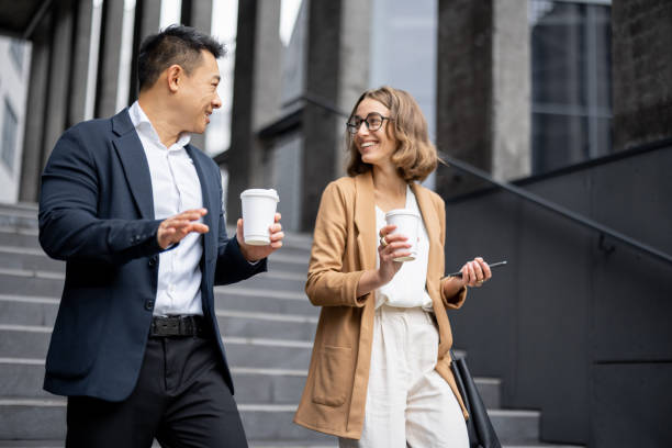 Business people walking and talking in city