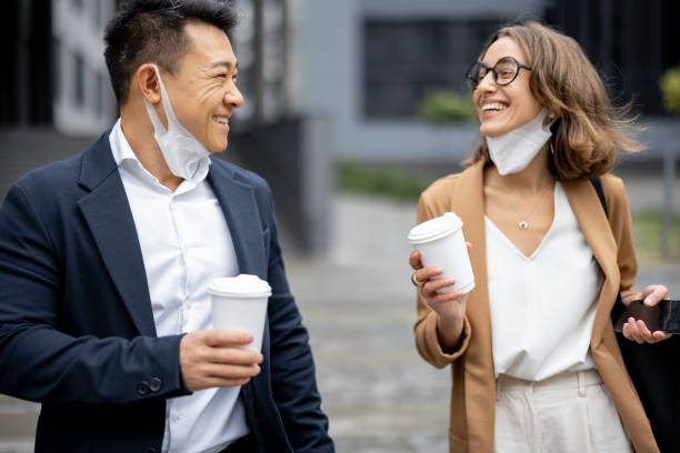 istock Business people walking and talking in city 1345841437