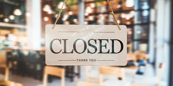 Closed sign in front of the cafe and restaurant doors, new ban on receiving customers