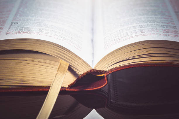 istock Open Bible on top of a glass desk. 1345842645