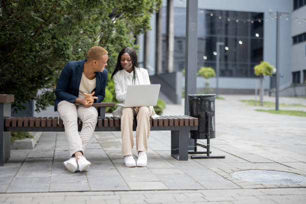 istock Business people talking and using laptop in city 1345842723