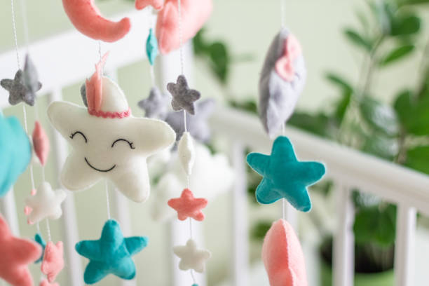 istock Textile soft toys rotate over the baby's crib. mobile for the cradle. 1345842816