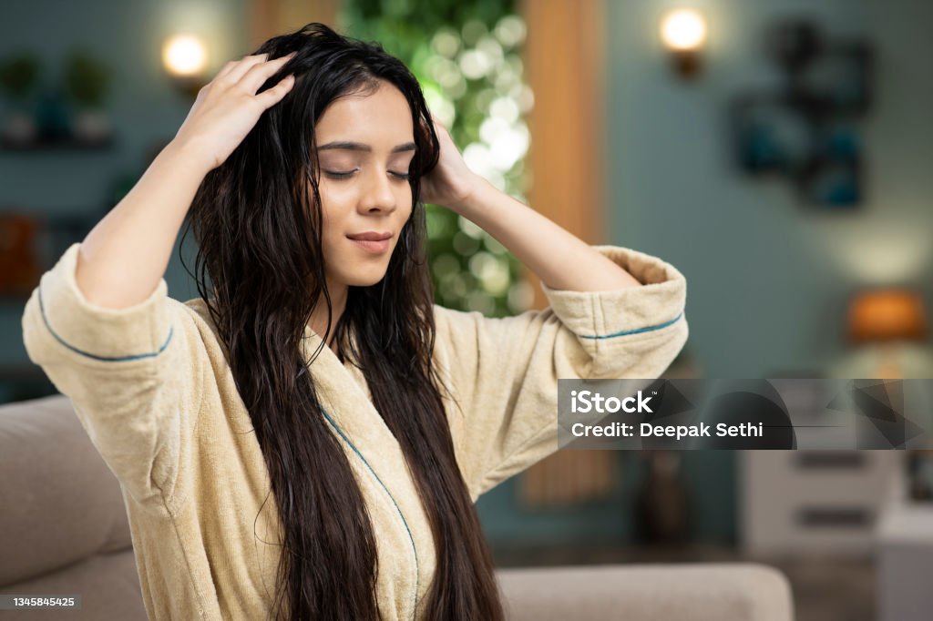 Young Woman hair care, stock photo India, hair care, hair oil, adult, adults only Hair Stock Photo