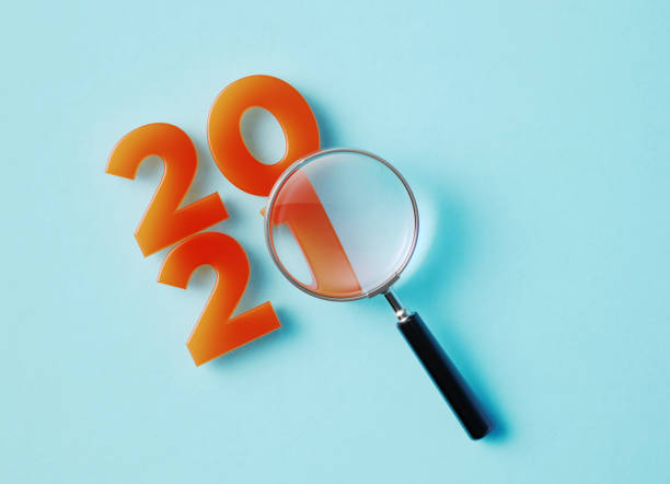 istock Magnifier And 2021 On Aquamarine Background 1345845464