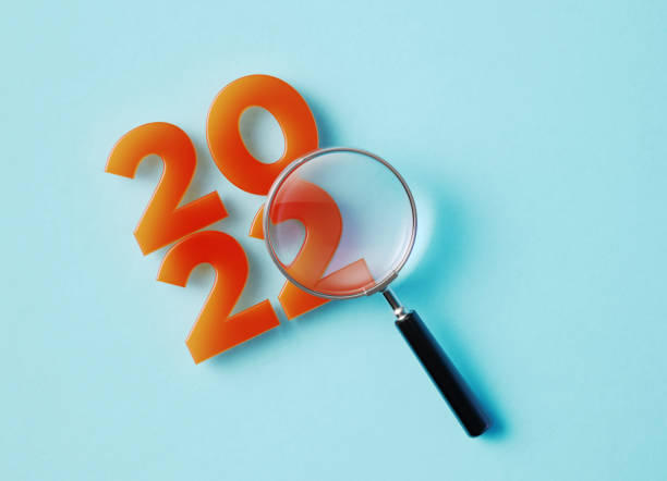istock Magnifier And 2022 On Aquamarine Background 1345845509