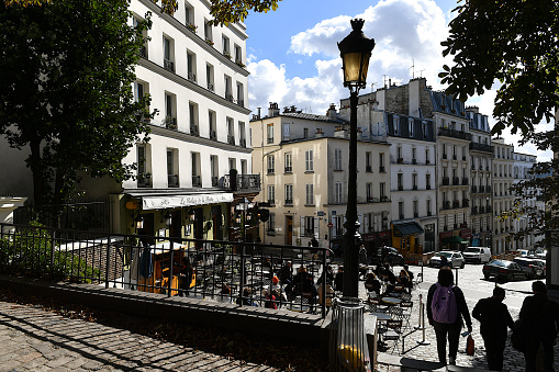 Paris, France-10 06 2021:People in a street and cafe terrace of Montmartre, Paris, France.