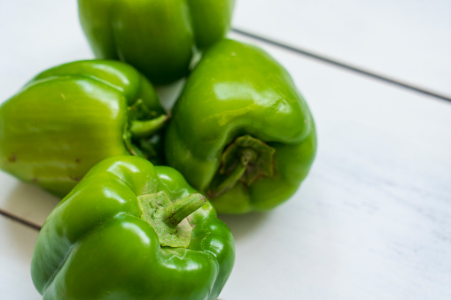 Fresh raw green organic Bell Pepper on wooden table