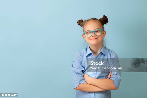 Happy Girl With Down Syndrome Having Fun And Laughing In The Studio Stock Photo - Download Image Now