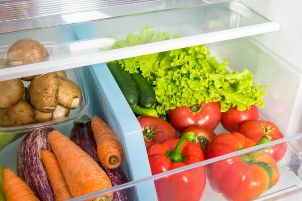 istock storing vegetables in a refrigerator drawer, close-up 1345850447