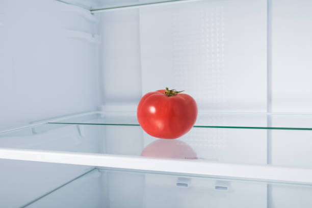 istock red tomato on a glass shelf in the refrigerator 1345850667