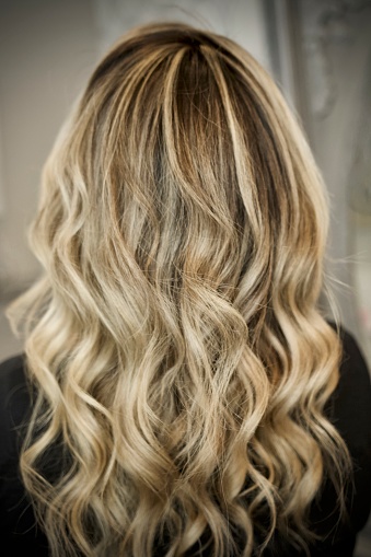 Beautiful long brown hair with blonde highlights and curl