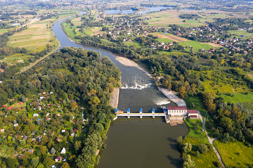 Aerial view of hydroelectric power plant on the river in summer landscape.
