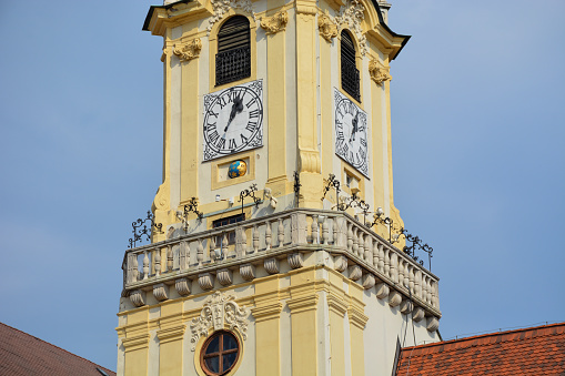 Bratislava, Slovakia, 2020:  The clock tower of Old Town Tower against a blue sky.