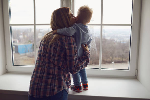 istock Mother and baby are looking out the window. 1345854571