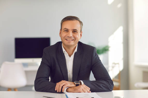 istock Smiling middle aged businessman looking at camera during online videocall or interview 1345854846