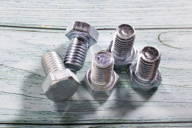 istock Galvanized short hex head bolts, on a wooden background 1345854860