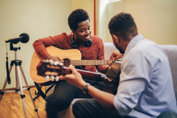istock Two Afro-American playing musical instruments at home 1345855758