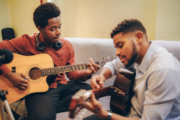 istock Two Afro-American playing musical instruments at home 1345855989