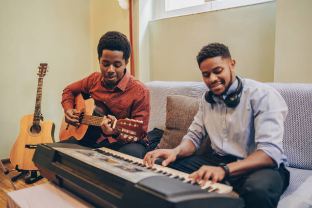 istock Two Afro-American playing musical instruments at home 1345856271