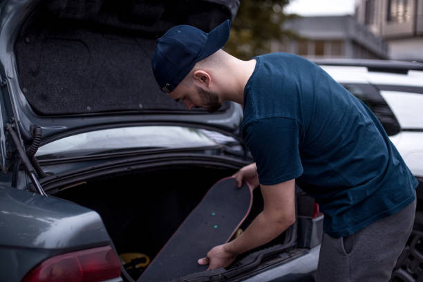 istock Young skateboarder packing / preparing his skate and gear 1345856331