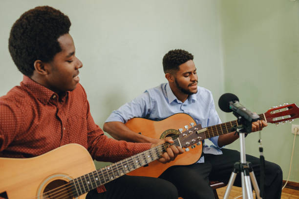 istock Two Afro-American playing musical instruments at home 1345856403