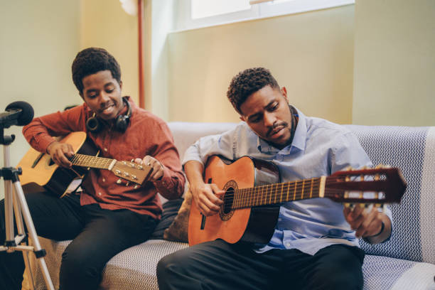 istock Two Afro-American playing musical instruments at home 1345857199