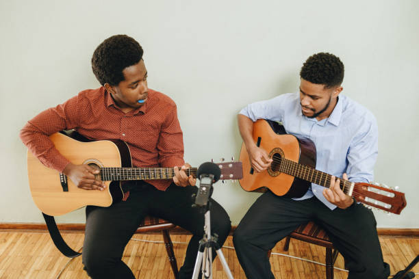 istock Two Afro-American playing musical instruments at home 1345857602