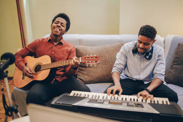 istock Two Afro-American playing musical instruments at home 1345857639