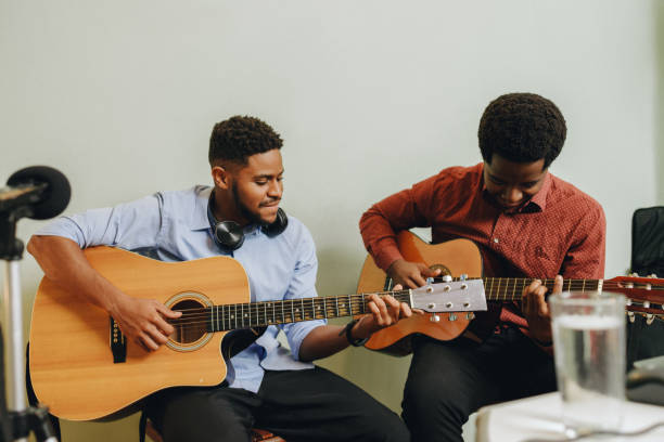 istock Two Afro-American playing musical instruments at home 1345857664