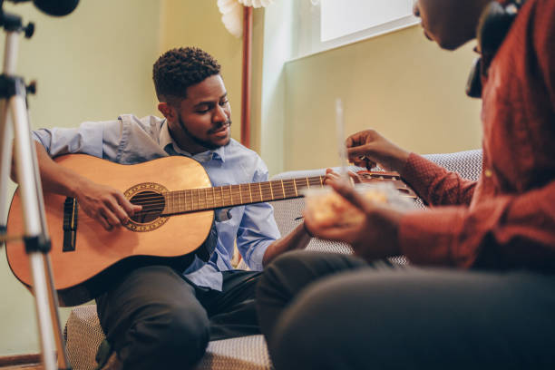istock Two Afro-American playing musical instruments at home 1345858656