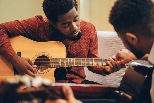 istock Two Afro-American playing musical instruments at home 1345858825