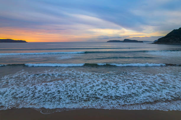istock Colourful high cloud covered sunrise seascape 1345858849
