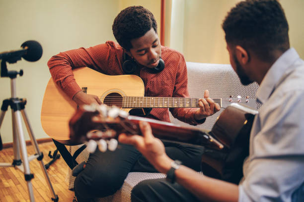 istock Two Afro-American playing musical instruments at home 1345858896