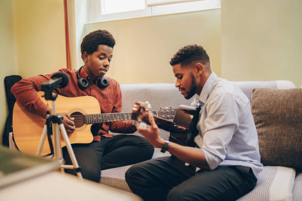 istock Two Afro-American playing musical instruments at home 1345858921