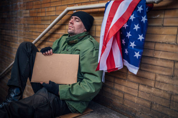 istock Homeless man sitting outdoors 1345859922
