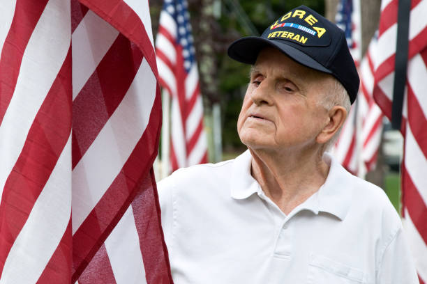istock Korean War Veteran admiring an American Flag 1345859959