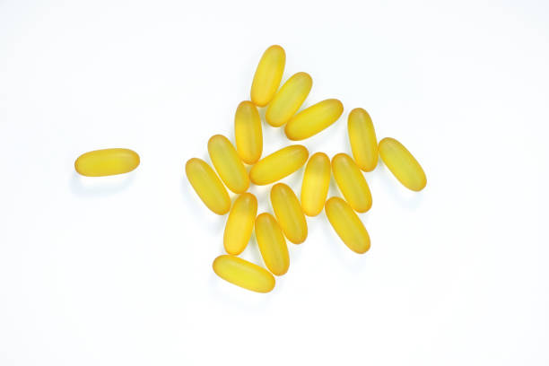 istock Yellow capsules on a white background. Omega 3 top view. 1345860461