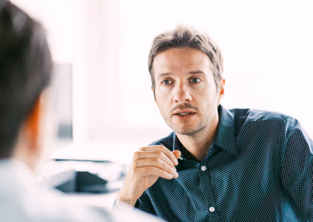 istock Businessman having a discussion with business partner at workplace 1345864012