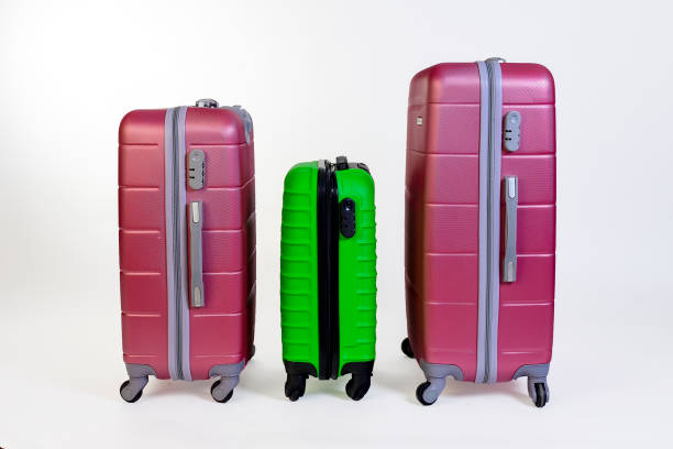 istock Elegant suitcases on a color background. 1345865550