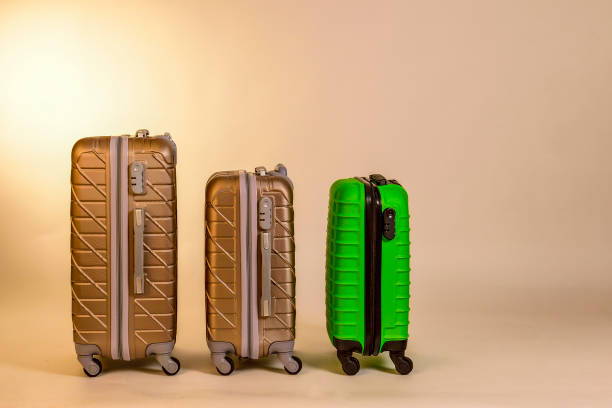 istock Elegant suitcases on a color background. 1345865552